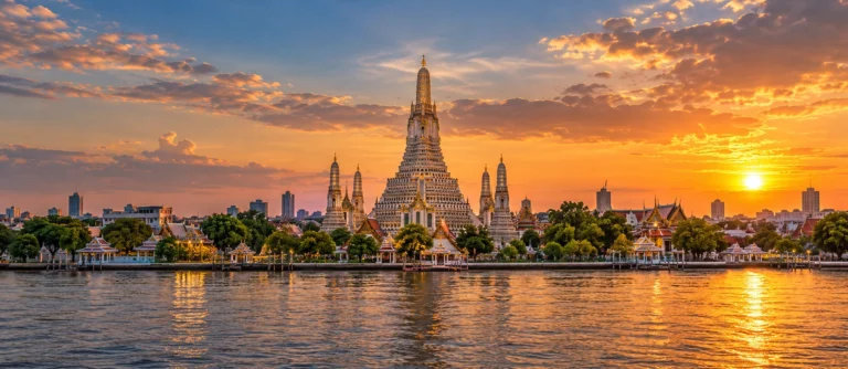 View of Wat Arun temple in Bangkok across the river at sunset